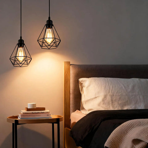 Black Pendant Lights 2 Pack Farmhouse Industrial Metal Cage Ceiling Fixtures over a bedside table in a bedroom.