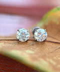 Premium D Color Moissanite Stud Earrings Crafted From Certified G23 Implant Grade Titanium Screw Back For Tragus Cartilage Labret Helix Piercings Nickel Free Hypoallergenic good vibes for sensitive skin slay game strong for women men 3MM size on brown leaf.