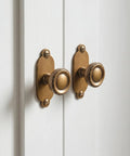 Top Notch Heavy Duty Solid Zinc Cabinet Knobs With Vintage Oval Beaded Back Plates Antique Brass Finish Six Pack installed on cabinets.