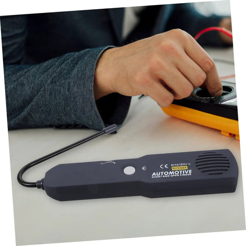 Must Have Multi Functional Car Short Circuit Tester And Wire Breaker Tracker Kit placed on a table next to technician's hand