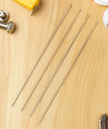 Four brass round dowels on wood surface, for DIY knife handle kits, Two Brass Knife Pins For DIY Knife Handle Kits And Repairs