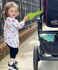 Toddler holding Detachable Toddler Stroller Handle For Child Safety Keeps Kids Close And Ready For Travel Must Have Accessory