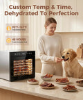 Eight Tray Stainless Steel Food Dehydrator With Digital Timer And Precise Temperature Control Auto Shut Off Ultra Quiet 650W Motor For Homemade Jerky Dried Fruits And Custom Dog Treats Keeps Your Snack Game Legit with woman feeding dog