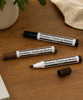 Deliver A No Sweat Slick Finish With This Elite Furniture Fix Kit Featuring Three Premium Wood Touch Up Markers In Rich Black Cherry Walnut Tones To Knock Out Stubborn Scratches And Freshen Up Floors Or Cabinets Fast. Three furniture touch-up markers in black, cherry, and walnut on wooden surface.