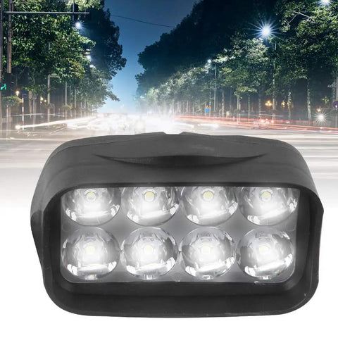 Ultra Bright Universal Headlight 12V To 100V LED Light For Electric Bikes Motorcycles And Trikes Clear Night Vision Low Power Draw Easy Install All In One Ride Ready shown on a nighttime city street background.