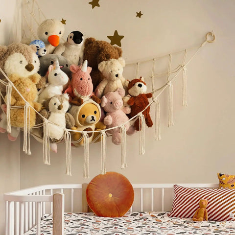 Stuffed Animal Storage Hammock Net For Corners And Walls, holding plush toys in kid's room above crib, beige macrame.