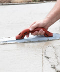 Person using Round End Magnesium Hand Float For Concrete Finishing With DuraSoft Handle, Pro Grade Lightweight Magnesium Blade.