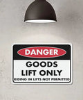 Danger sign reading 'Goods Lift Only' under industrial lamp, similar to Keep Out Zone Sign For 8x12 Inch Warehouse Equipment Access Restriction.