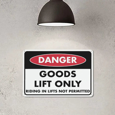 Danger sign reading 'Goods Lift Only' under industrial lamp, similar to Keep Out Zone Sign For 8x12 Inch Warehouse Equipment Access Restriction.