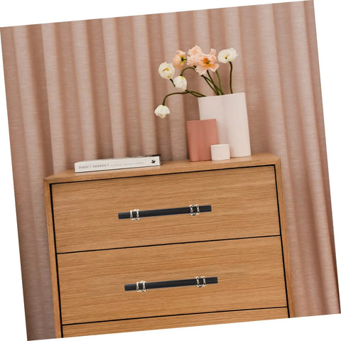 Wood dresser with Aluminum Alloy Drawer Handles And Cabinet Pulls Kit in black finish, featuring modern floral decor on top.