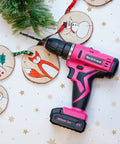 Pink Cordless Drill Set For Women, 12V Rechargeable Li-Ion Battery Kit with holiday decorations and DIY ornaments.