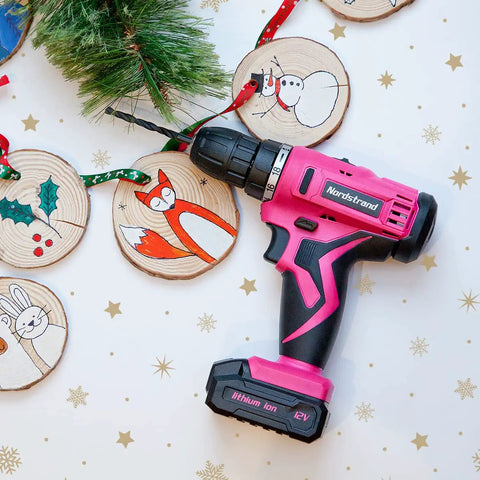 Pink Cordless Drill Set For Women, 12V Rechargeable Li-Ion Battery Kit with holiday decorations and DIY ornaments.