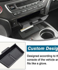 Close-up of black removable center console tray organizer in Honda Pilot dashboard cubby with custom design information.