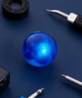 Blue Rubber Ball Watch Case Back Opener For Battery Replacement on blue surface with tool accessories