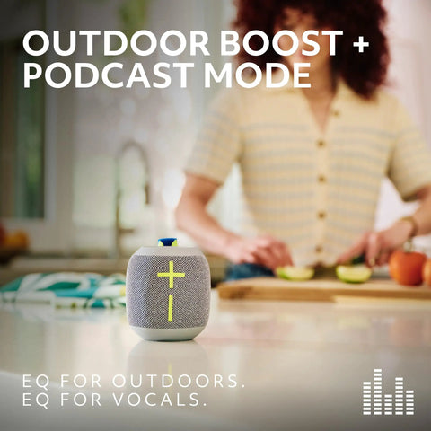 Wonderboom 4 Portable Bluetooth Speaker with Waterproof Floating Design on kitchen counter, woman preparing food in background.