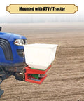 Tow Behind Front Mount Broadcast Spreader For ATV Or Tractor 265Lb Capacity mounted on blue tractor in field