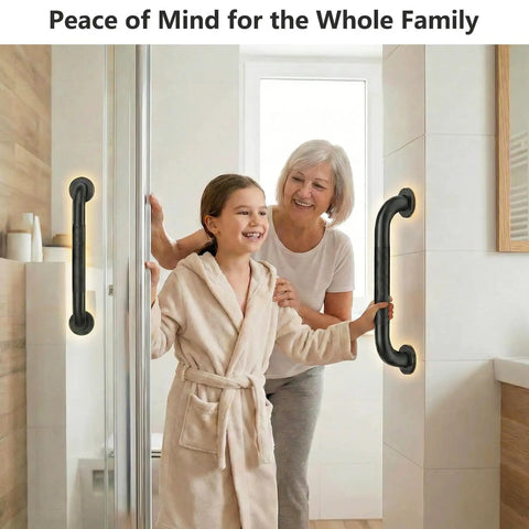 Rock Solid 16 Inch Wall Mount Handrail Matte Black Steel Pipe Grab Bar used by a woman and girl in a bathroom for safety.