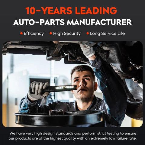 Mechanic inspecting vehicle undercarriage with light in auto-parts manufacturing shop.