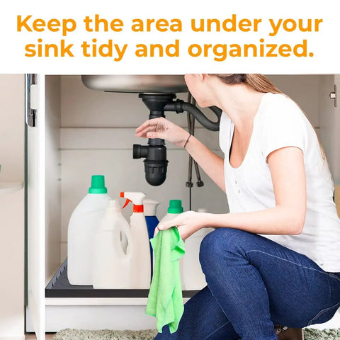Woman organizing under sink cabinet with Under Sink Mat for 36 Inch Standard Cabinets Durable Silicone Drip Tray.