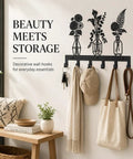 Knockout Premium Decorative Floral Metal Wall Coat Rack Featuring Six Heavy Duty Hooks And Matte Black Finish for everyday uses, displaying hats and keys.