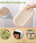 Person holding 34 oz sugarcane pulp takeout container with lid; shown microwave and freezer safe