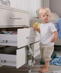 Child standing by dresser with 100 Pieces Brushed Stainless Steel Cabinet Pulls 3 Inch Hole Center Handles, open drawers with clothes.