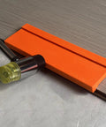 Pro Grade Three Edge Tapping Block For Vinyl Flooring And Laminate Installations with hammer, showing 3.5mm bevel edge use.