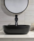 Black Rectangle Vessel Sink 18x13 Above Counter Porcelain Ceramic With Faucet And Drain Combo in modern bathroom setting.