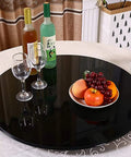 Top Shelf 31 Inch Black Tempered Glass Lazy Susan Turntable with a totally slick spin, set with glasses and fruit platter on dining table.