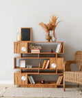 Wooden shelf with decorative items and wicker chair in modern living room