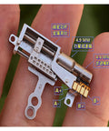Close-up of a 11.5mm Stroke Linear Actuator With 5mm Precision Planetary Gearbox Pro Grade held on fingertip showing gearbox details.