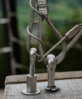 Top Tier 304 Stainless Steel M5 X 40mm Shoulder Eye Bolts Rigging Hardware Fasteners 4 Pack attached to cables on wood.