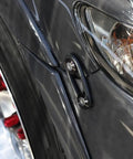 Side view of JDM Black Bumper Quick Release Fasteners Kit with rubber band installed on a car bumper near headlight.