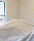 Room with furniture covered by Heavy Duty 12oz Cotton Duck Canvas Drop Cloth 20x20 Ft Washable And Reusable Floor Protector