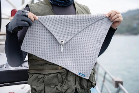 Grab And Go Clip On Microfiber Fishing Towels With Waffle Pattern, Quick Dry 16x16 Inch Towels For Cleaning, displayed in hand.