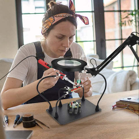 Person using Soldering Desk Magnifier With Heavy Duty Base Adjustable Swivel Arm 5 Diopter Real Glass Lens Three Color LED Modes PCB Circuit Board Holder