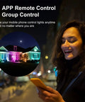 Woman controlling 4 Pack Smart LED Flood Lights 20W RGBCW Color Changing Outdoor Flood Lights 2700K To 6500K via smartphone app