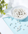100 Piece Pearl Rivets And Pins Kit For Clothing Decoration 6mm White Round Plastic Pearl Buttons in bowl on blue background