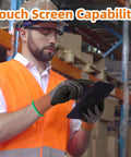 Man wearing 6 Pairs Sandy Nitrile Coated Safety Work Gloves Level 6 Abrasion Resistance using a touchscreen in a warehouse.