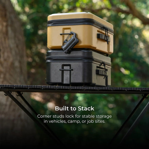Stacked Nestout Go-To Gear Storage Case Lightweight Hard Shell Organizer with Water Resistant design on outdoor table.