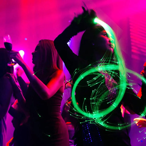 Performer using Lit Up Fiber Optic Dance Whip Rechargeable 6ft Space Whip With 360 Swivel And 36 Modes Pixel Flow Rave Toy
