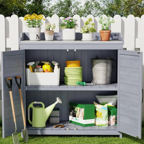 Outdoor Potting Bench With Metal Tabletop And Double Doors Cabinet, weatherproof shelf with garden tools and plants.
