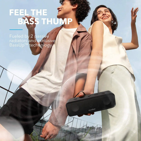 Two people holding 3 Portable Bluetooth Speaker That Delivers Dope Sound With IPX7 Waterproof Build 24 Hour Playtime outdoors.