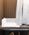 Straight Up Sleek White Plastic Foldable Storage Basket Pull Out Wardrobe Drawer Organizer For Clothes Books Makeup Nifty Space Saver Bin That Kicks Clutter To The Curb Fast on a shelf with a white shirt.