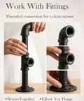 Hands assembling Ten Pack Three Quarters Inch By Two Inches Black Malleable Iron Pipe Nipples Fitting With Threaded Ends