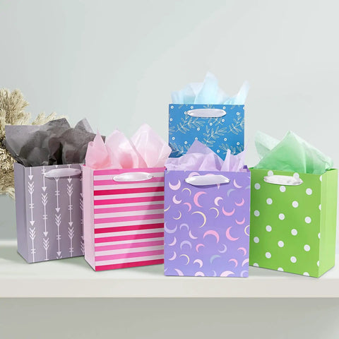 Party Ready 12 Pack Gift Bags Assorted Sizes With Tissue Paper Bulk Set arranged on a shelf with various colors and patterns.