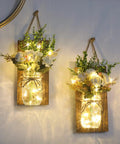 Remote Control Mason Jar Sconces Set Of Two With LED Fairy Lights And White Rose Accents on rustic boards for cozy wall decor.