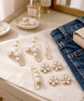 8 Piece Pearl Waist Tightener Pins For Loose Jeans And Pants Belt Alternative Clip Decorative Alloy Brooch on a table with denim