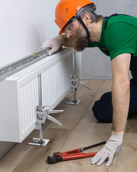 Worker using Two Pack Labor Saving Arm Jacks For Lifting Furniture With 330 Lbs Capacity to install a radiator