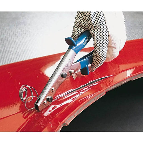 Expert Hand Nibbler For Metal Sheets And Plastic, 250 mm Cutting Capacity, making clean cuts on red metal surface, slip guard handles visible.